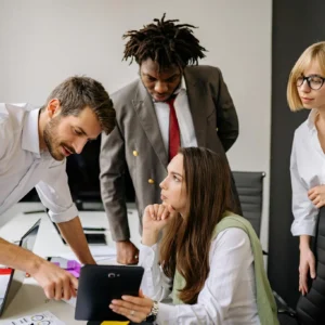A group of professionals engaging in a collaborative business meeting in a modern office.